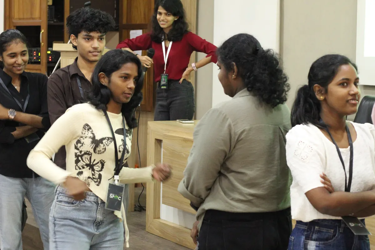 A group of students in conversation near the podium