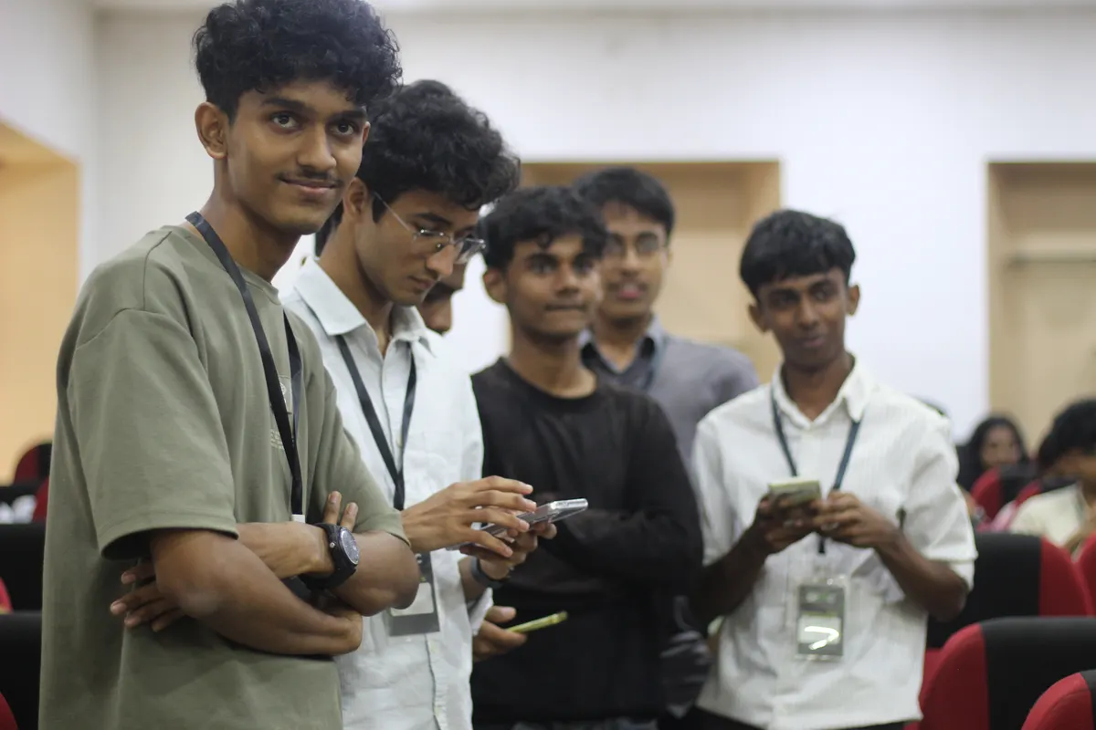 Students leaning in to look at something on a phone together