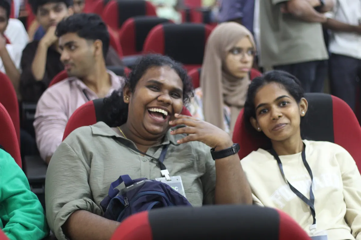 Students laughing in their seats during a session