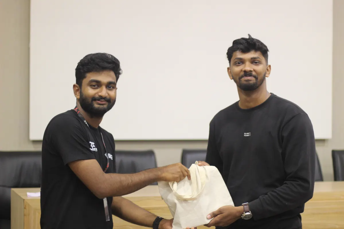 A goodie bag being handed from one student to another