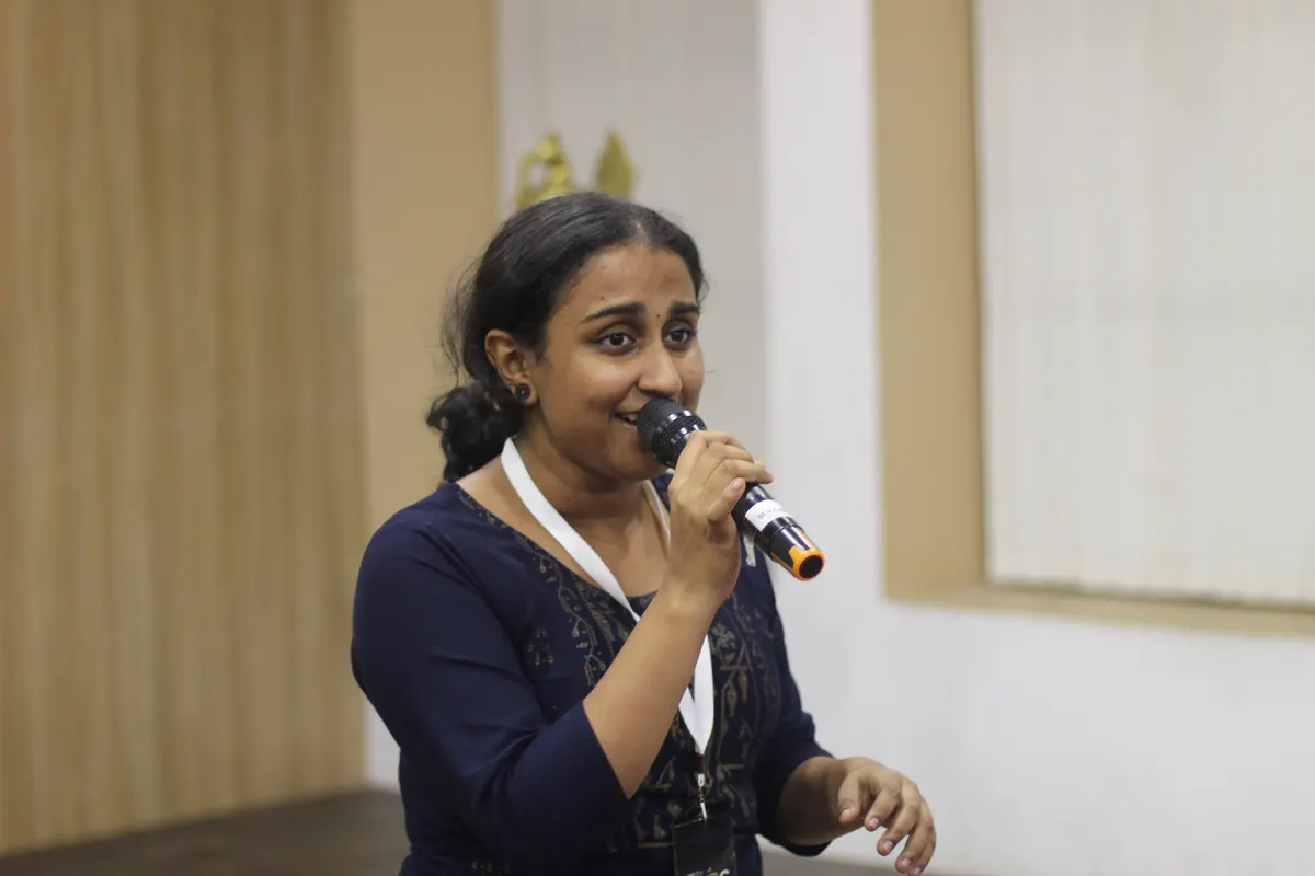 A speaker addressing the audience with a microphone